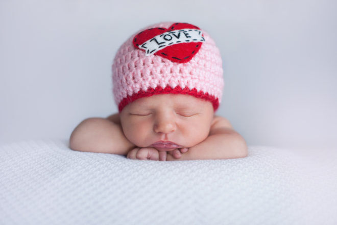Newborn Baby Girl Wearing a "Love" Hat