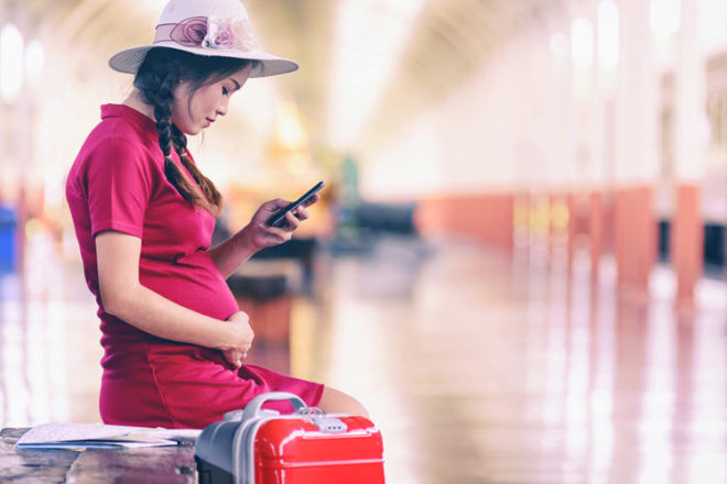 Pregnant women sitting at airport
