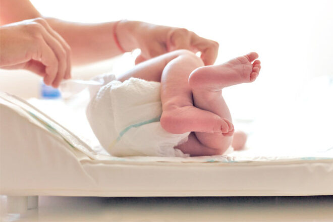 Newborn having nappy changed
