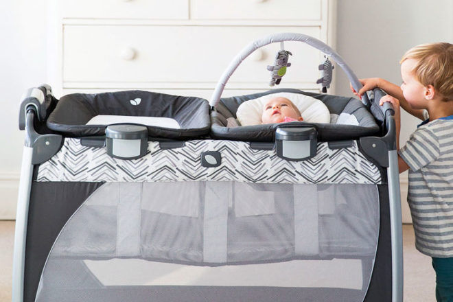 baby sleeping in travel cot