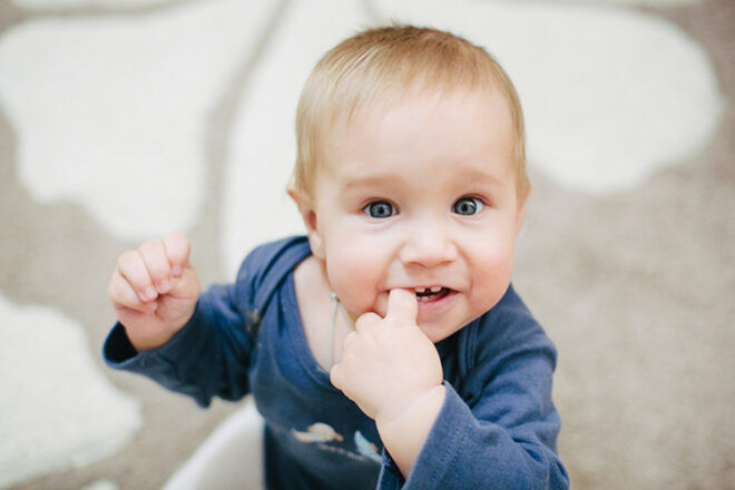 baby with fingers in mouth